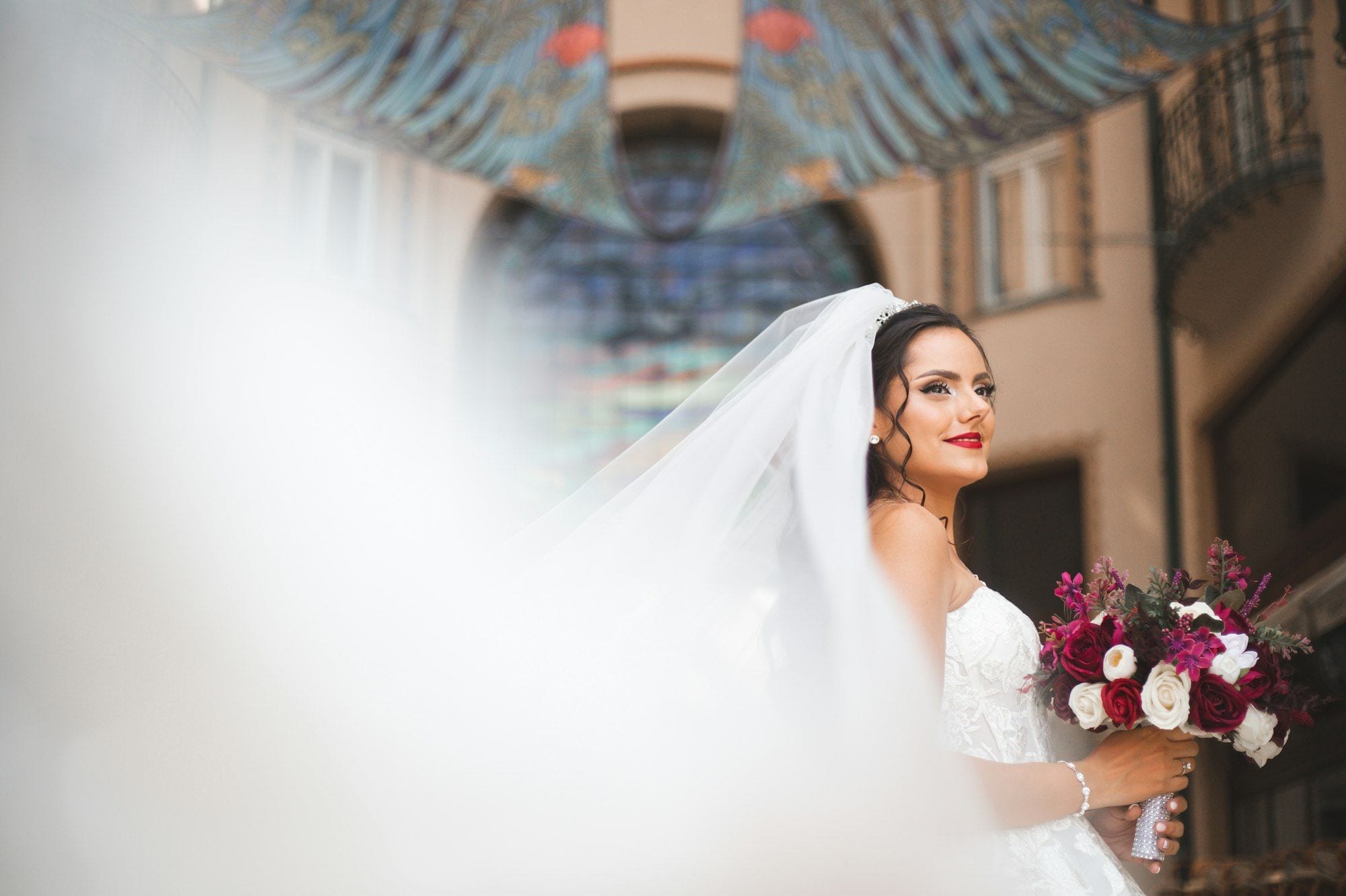 A bride outdoors on her wedding day, photographed in natural light
